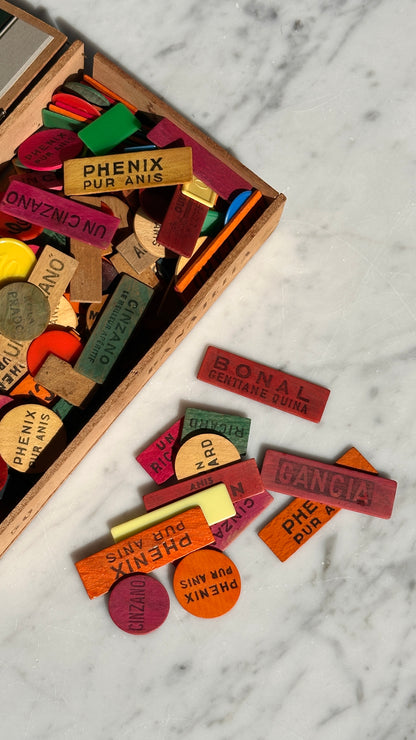 Collection of Advertising / Bar Tokens in Vintage Nicoleto Cigar Box