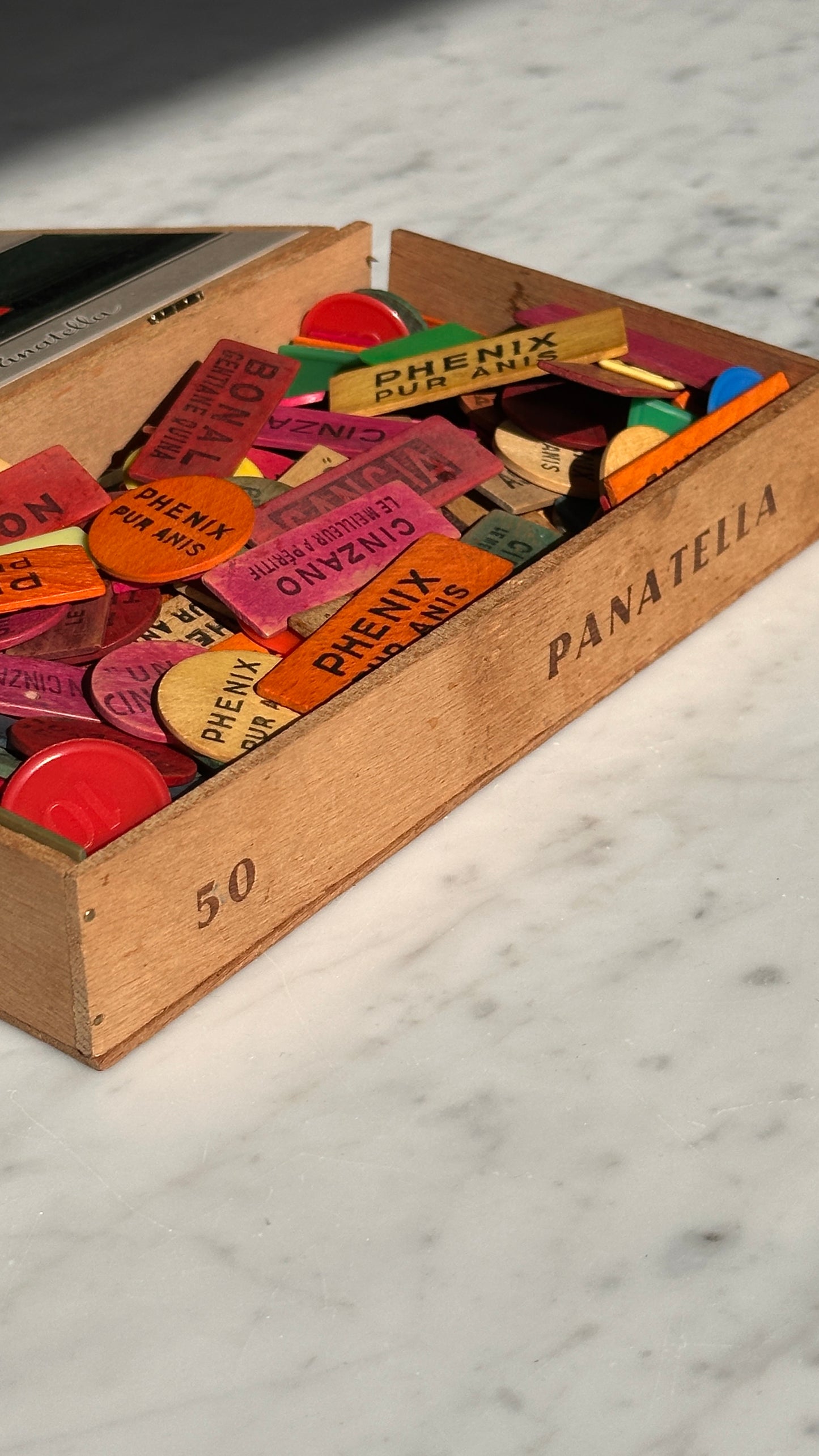 Collection of Advertising / Bar Tokens in Vintage Nicoleto Cigar Box