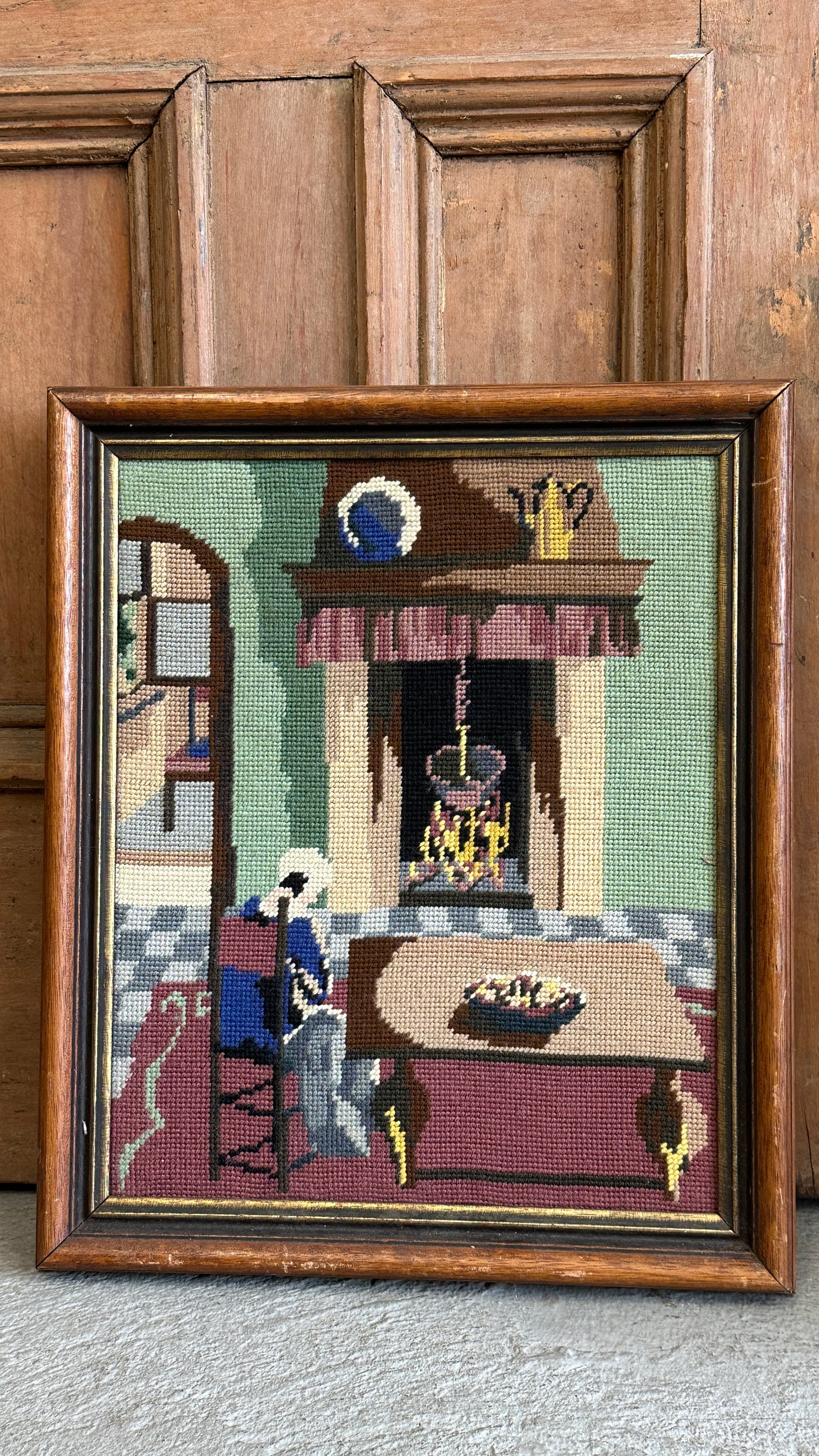Framed Needlepoint of Woman and Fireplace